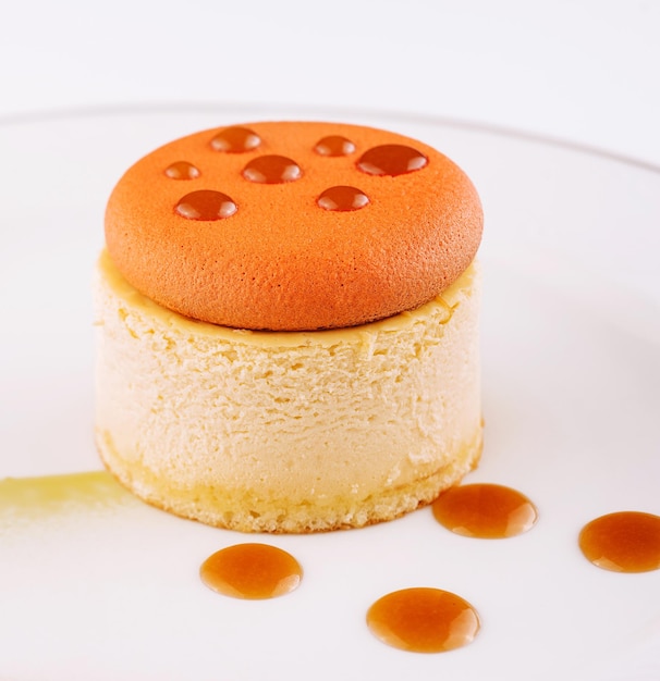 Piece of delicious cake with caramel on white plate