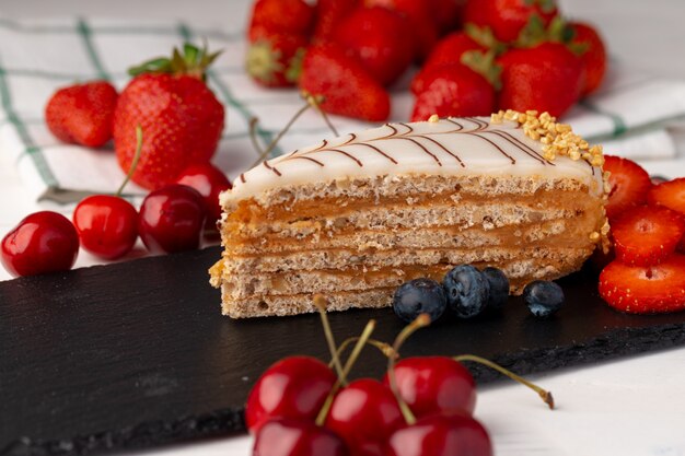 Piece of esterhazi cake decorated with fresh berries