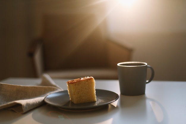 Piece of fresh homemade cake with cup of cappuccino on a table