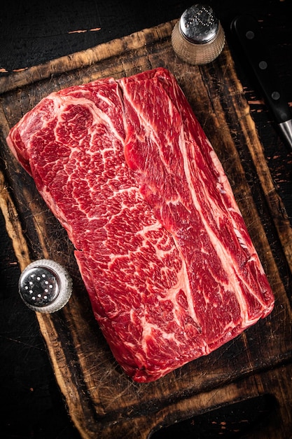 A piece of fresh raw beef on a cutting board
