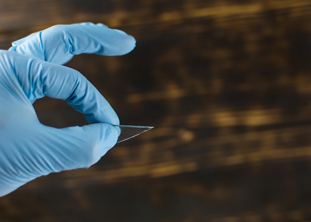 A piece of glass in the hand in the glove cleaning of broken
glass