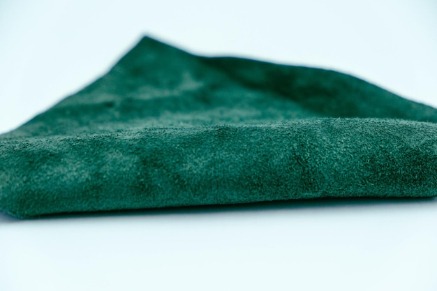 Piece of green leather and suede cut on white background