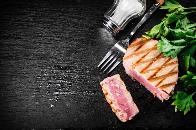A piece of grilled tuna with parsley