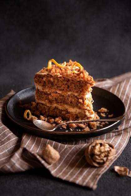 Piece of homemade cake with cinnamon on black plate