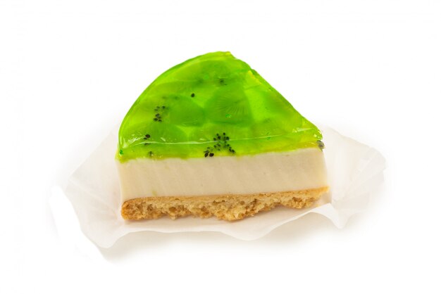 Piece of kiwi cheesecake isolated on white.