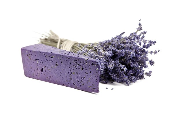 Photo piece of lavender cheese with dry basil and lavender flowers isolated