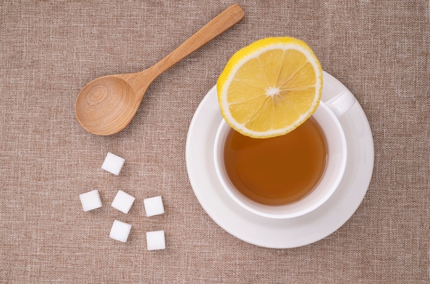 A piece of lemon levitating on a cup of tea.