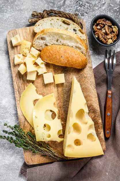 Piece of Maasdam cheese with large holes