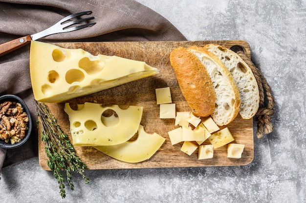 Piece of Maasdam cheese with large holes