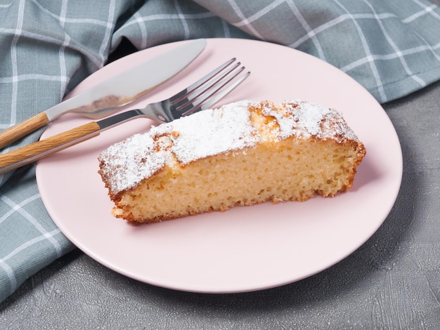 A piece of mannikin or semolina pie on a pink plate