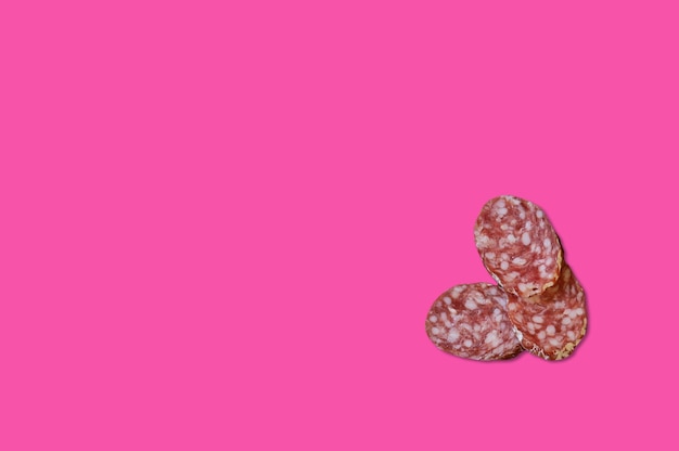 Piece of meat smoked bacon isolated on a pink background