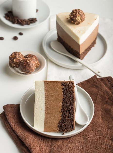 A piece of a mousse cake "three chocolate"  sprinkled with grated chocolate, and decorated candy