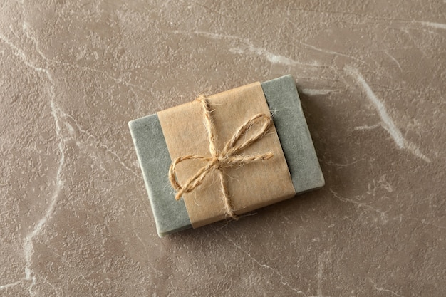 Piece of natural handmade soap on brown