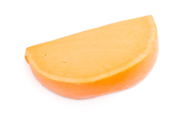 Piece of orange cheese isolated on white surface