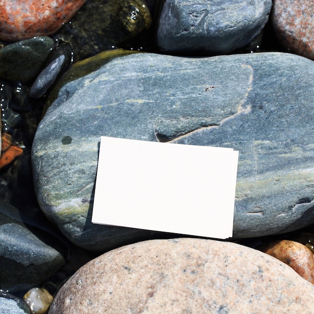 A piece of paper on a rock with the word " i " on it