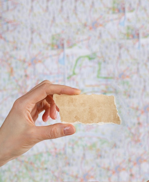 Piece of paper with free space for a text on a map. Closeup