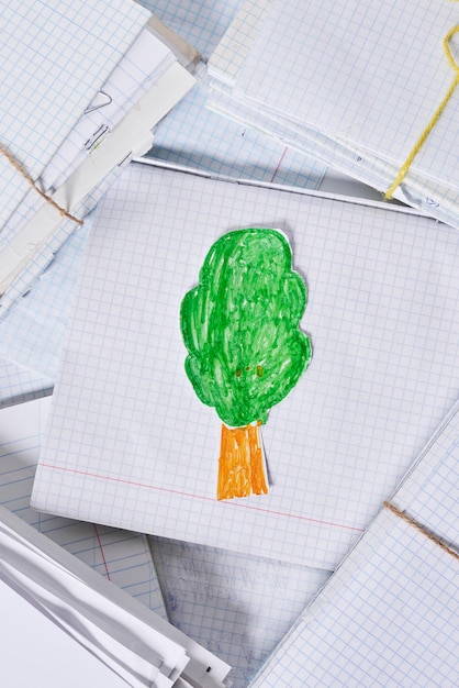 A piece of paper with a green tree on it