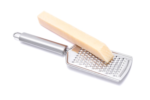 piece of parmesan cheese and grater isolated on white background