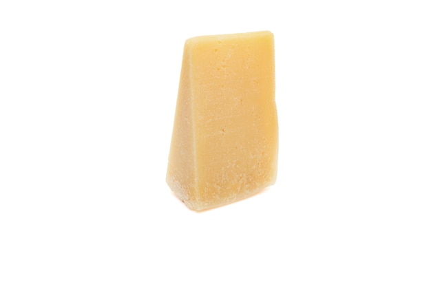 Piece of parmesan cheese isolated on white background. Block of Italian hard cheese close up view.