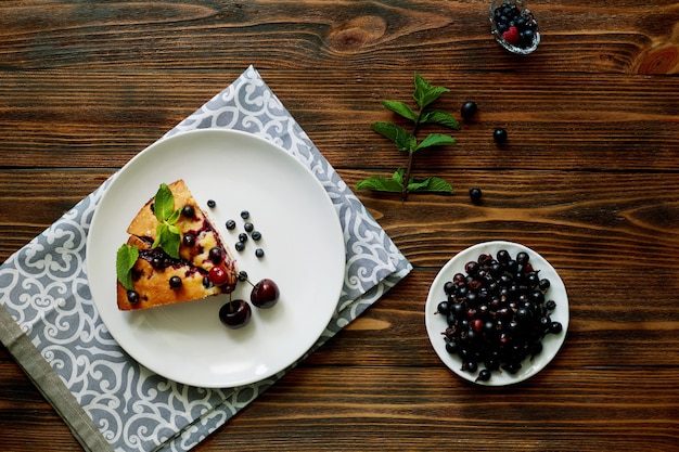 Piece of pie with blueberries, rasberry,cherries and mint for dessert