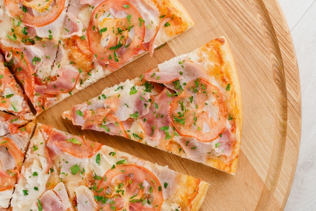 Piece of pizza close-up on the wooden desk