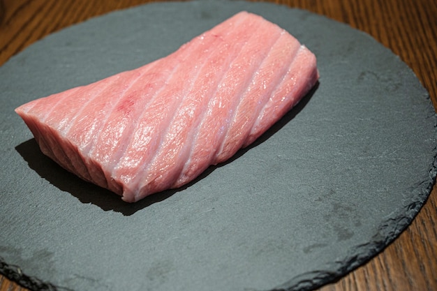 A piece of pork on a slate plate