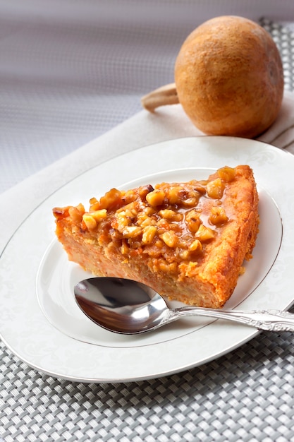 Piece of pumpkin pie with walnuts