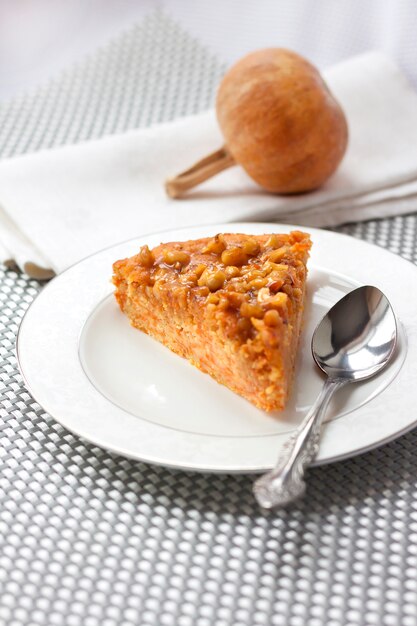 Piece of pumpkin pie with walnuts