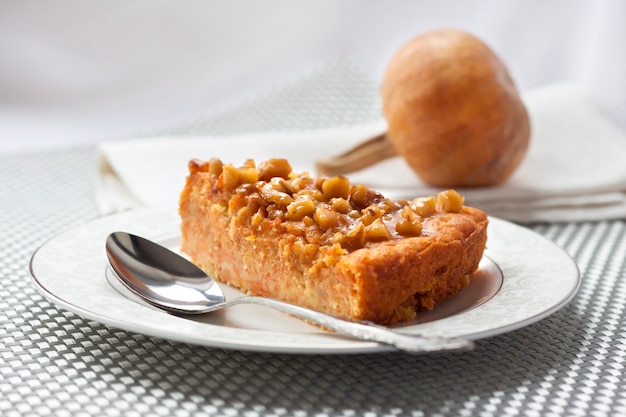 Piece of pumpkin pie with walnuts