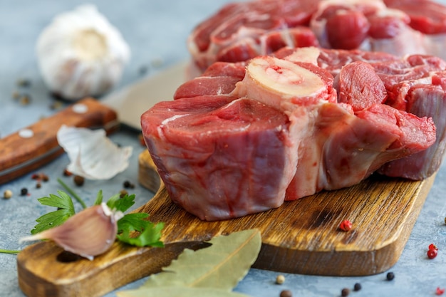 Piece of raw beef shank and spices closeup