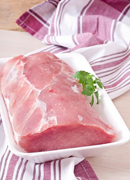 Piece of raw pork meat on the table