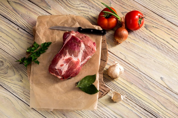 A piece of raw pork on a wooden table