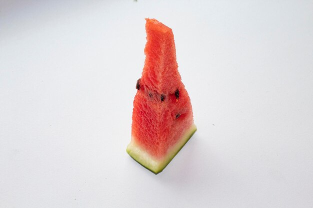 Photo a piece of ripe red watermelon on a white background