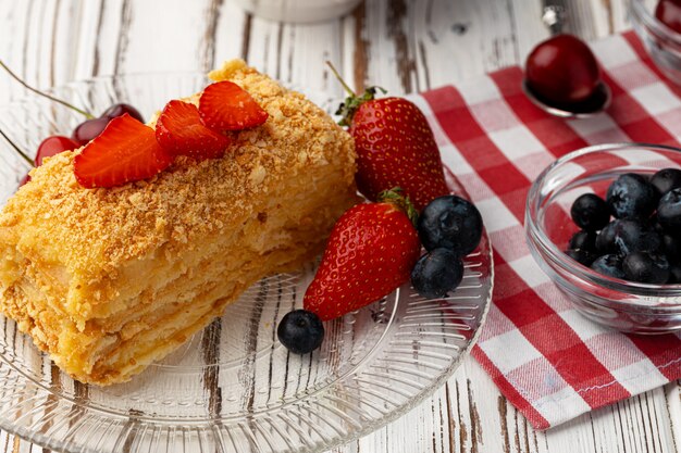 Piece of russian honey cake medovik served with berries