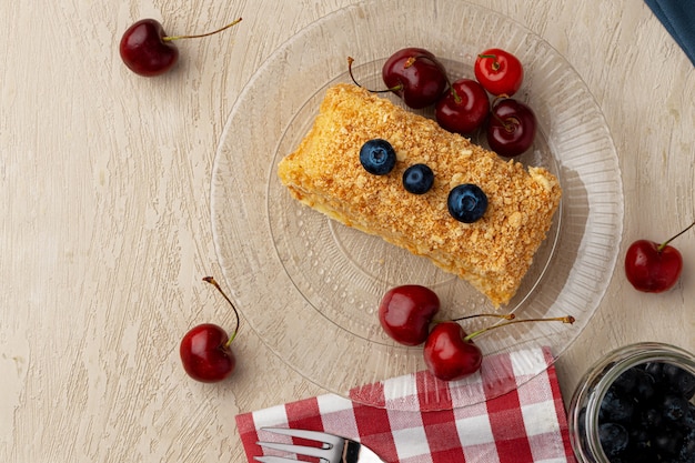 Piece of russian honey cake medovik served with fresh berries