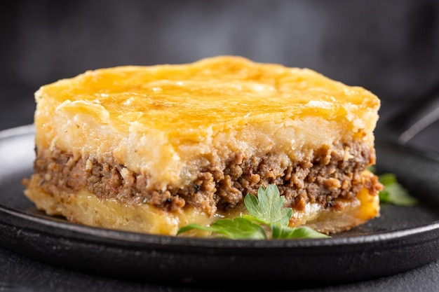 Piece of shepherd's pie on dark plate