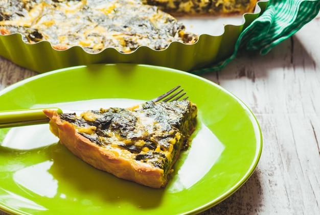 Piece of Spinach Tart on a green plate