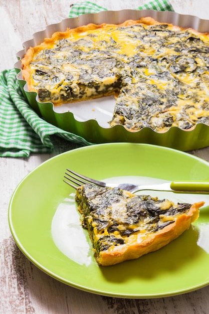 Piece of Spinach Tart on a green plate