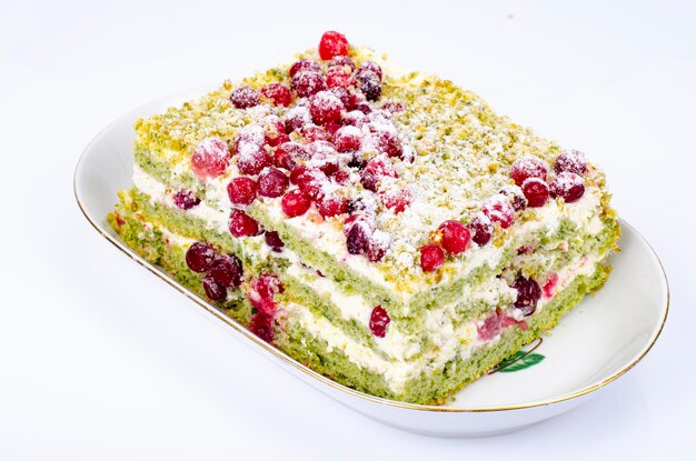 Piece of sweet sponge cake with cream and red cranberries Studio Photo