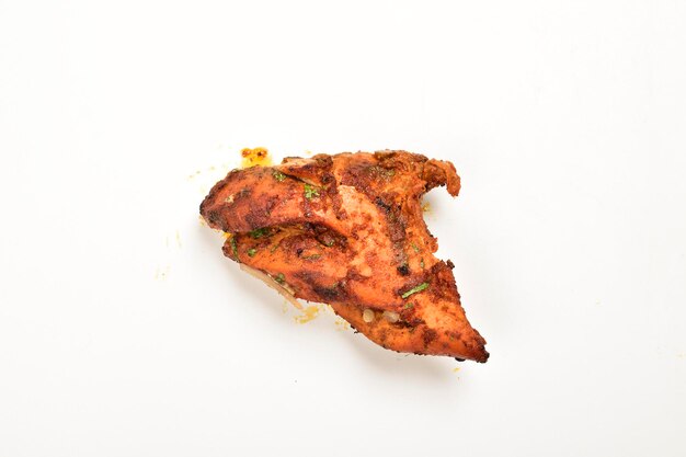 Piece of tandoori chicken isolated on white bakground