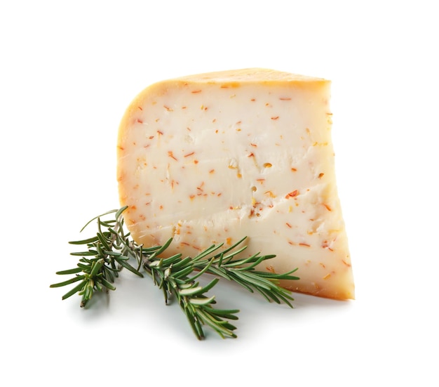 Piece of tasty cheese and rosemary on white background