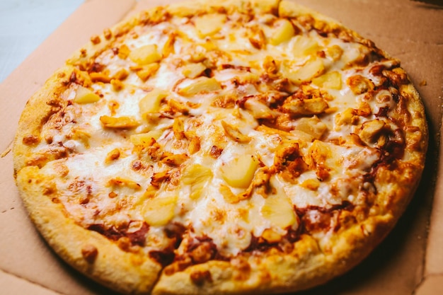 a piece of very tasty pizza with pineapple slices and cheese closeup vintage photo processing