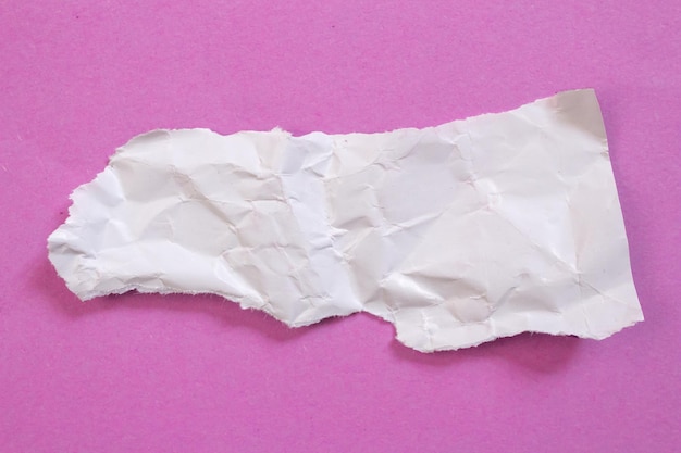 A piece of white paper with a torn edge is torn off