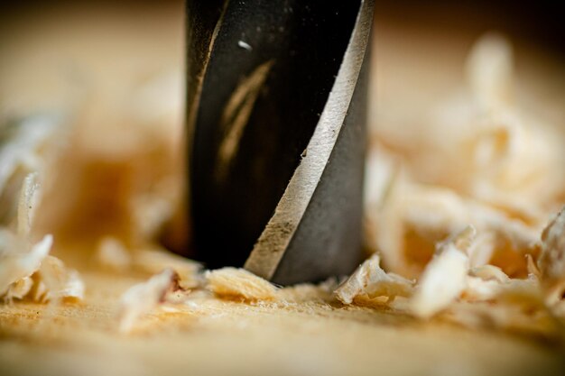 Piece of wood is drilled with shavings