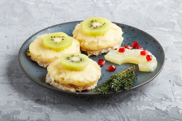 Pieces of baked pork with pineapple, cheese and kiwi