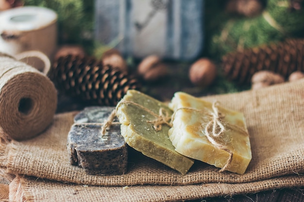 Pieces of beautiful natural handcrafted soap on wooden table