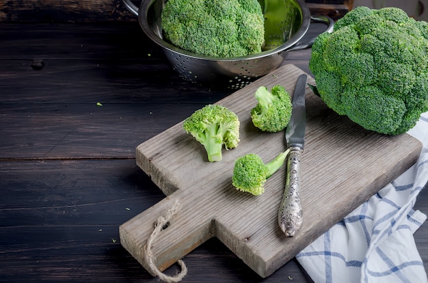 Pieces of broccoli, rustic style, old wooden background