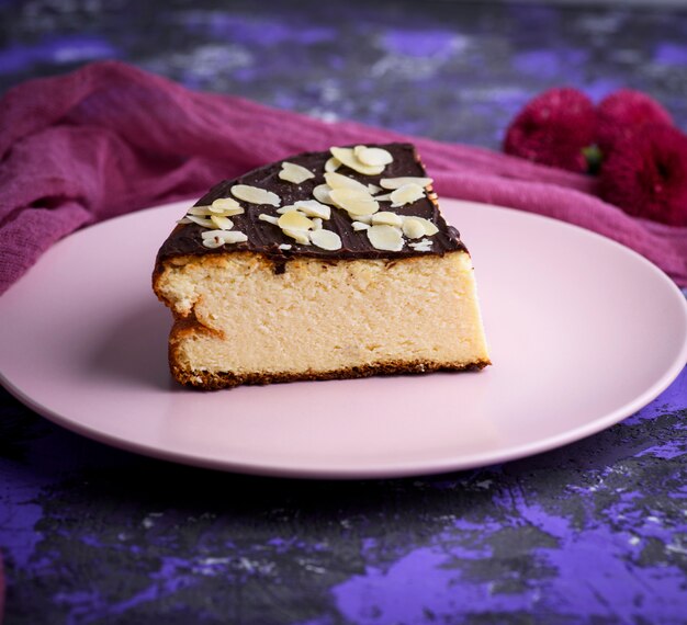 Pieces of cheesecake with chocolate on a pink plate