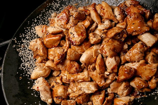 pieces of chicken in sweet and sour sauce closeup photo