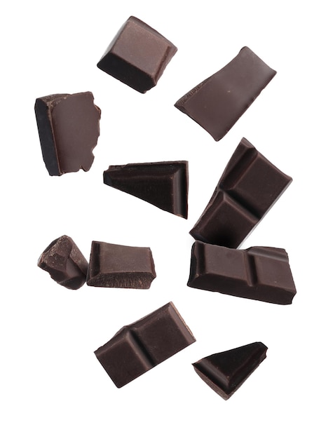 Pieces of chocolate bar falling on white background